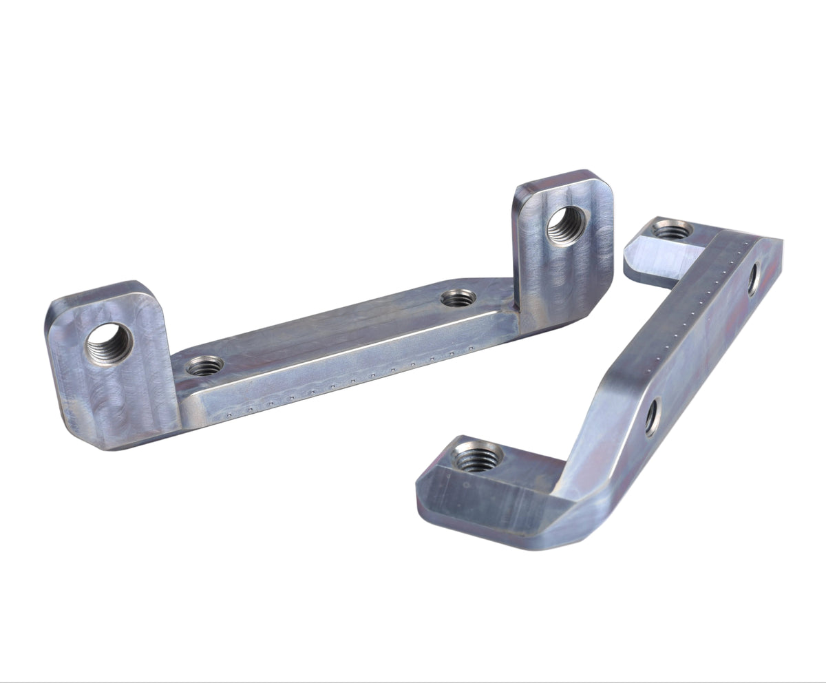 Two metallic silver anodized aluminum mounting brackets with threaded holes, displayed on a light beige background.